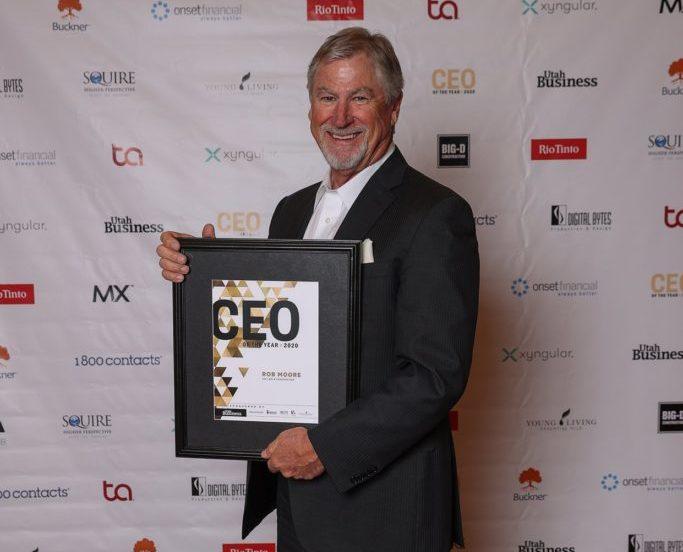 Rob Moore holding up his CEO of the Year award.